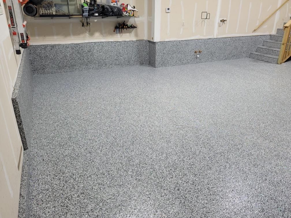 A garage with a gray floor and white walls.