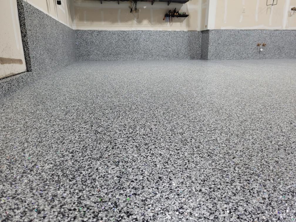 A garage floor with a lot of small stones on it.