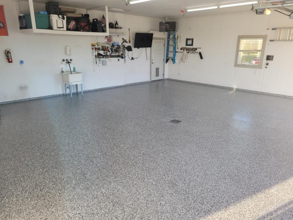 A garage with a sink and a tv on the wall