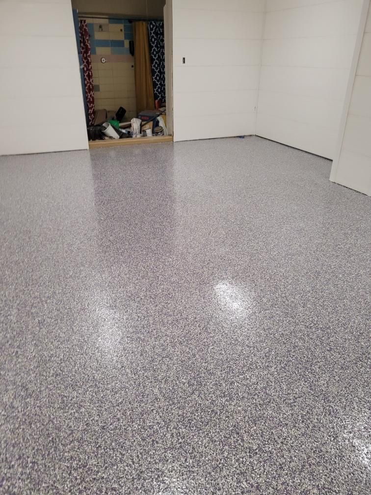 A room with a gray floor and white walls.