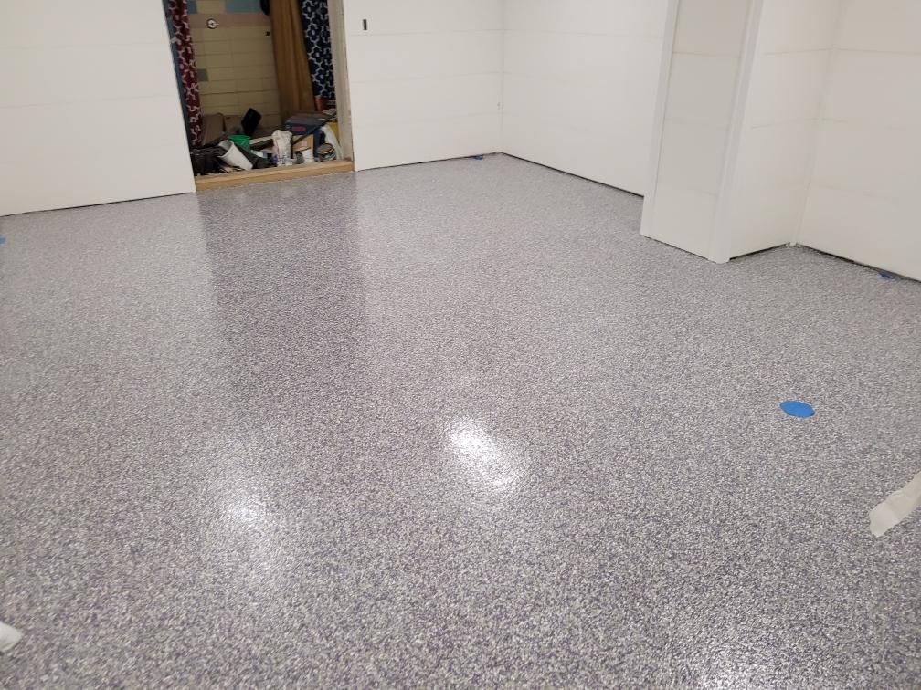 A room with a gray floor and white walls.