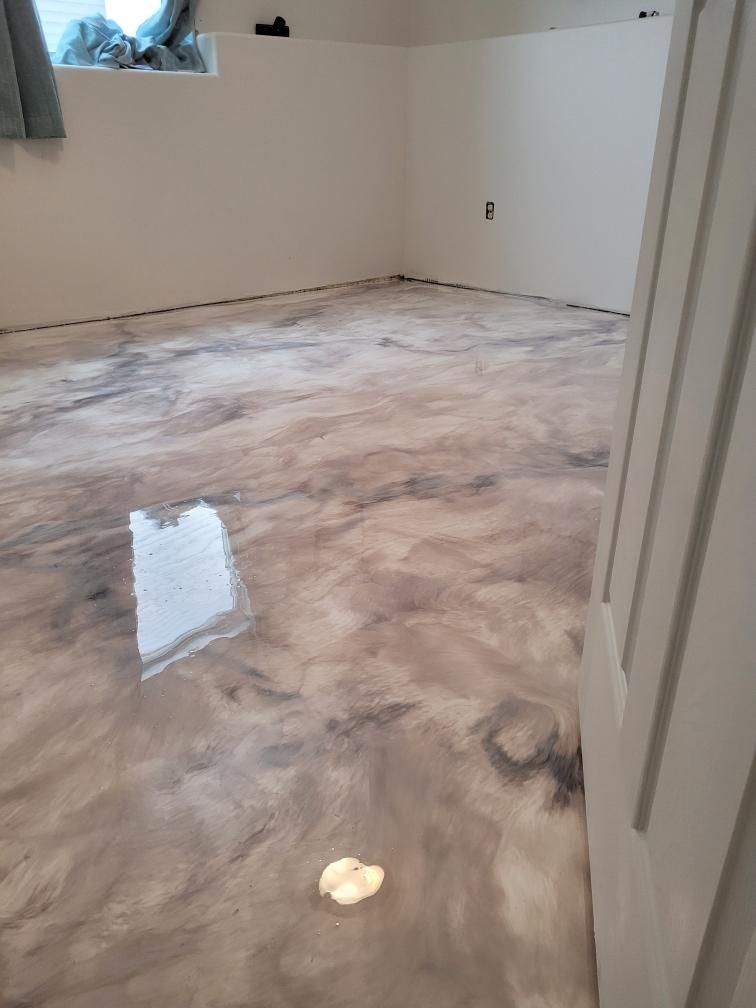 A room with a marble floor and a white door.