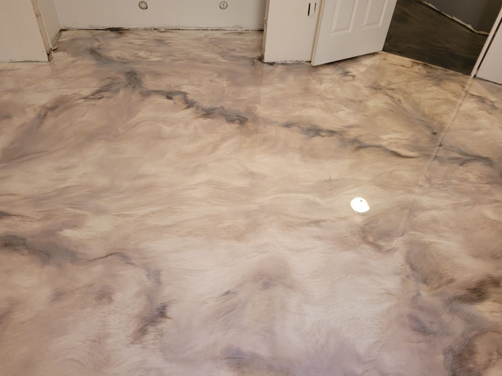 A room with a marble floor and a door.