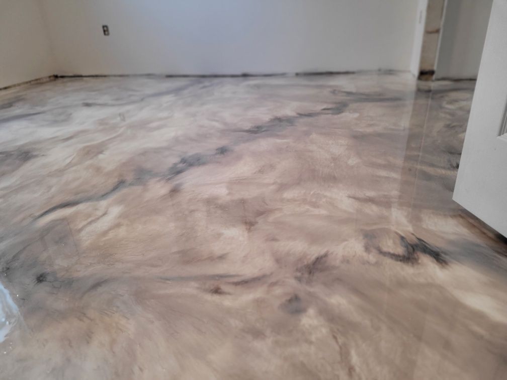 A room with a marble floor and a door.