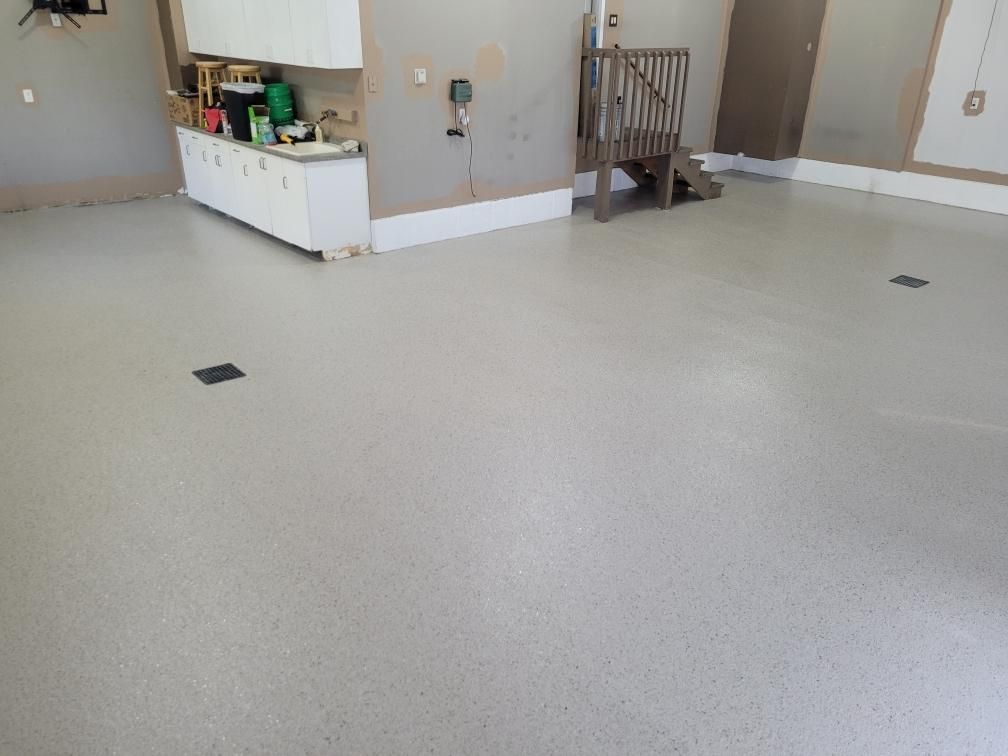 A large room with a white floor and white cabinets.