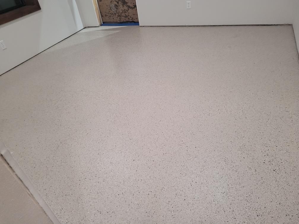 A white floor in a room with a door in the background.