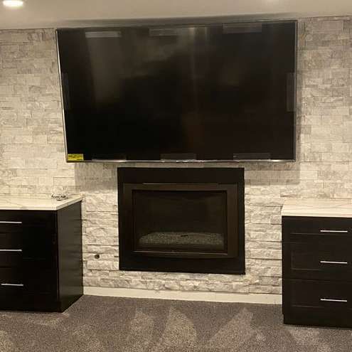 A living room with a fireplace and a flat screen tv.