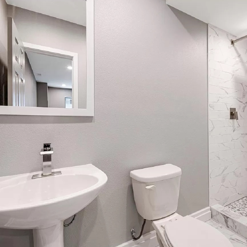 A bathroom with a sink , toilet , and mirror.