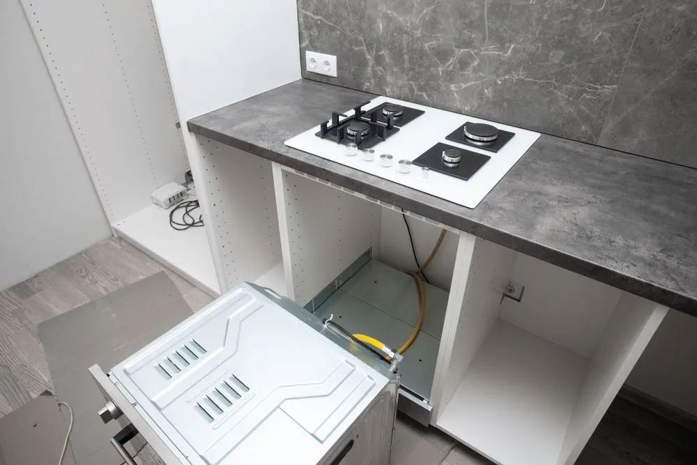 Modern Kitchen With White Cabinets and Gray Countertop — The Plumbing & Drainage Co. in Mittagong, NSW