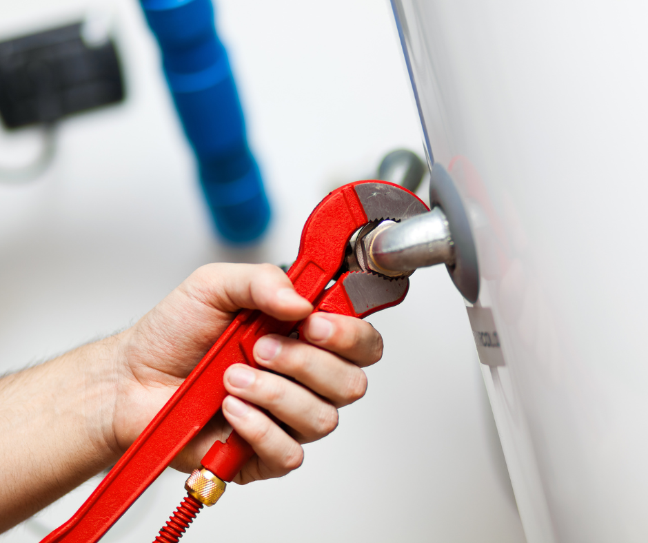 A man is fixing a sink in a kitchen with a plunger.