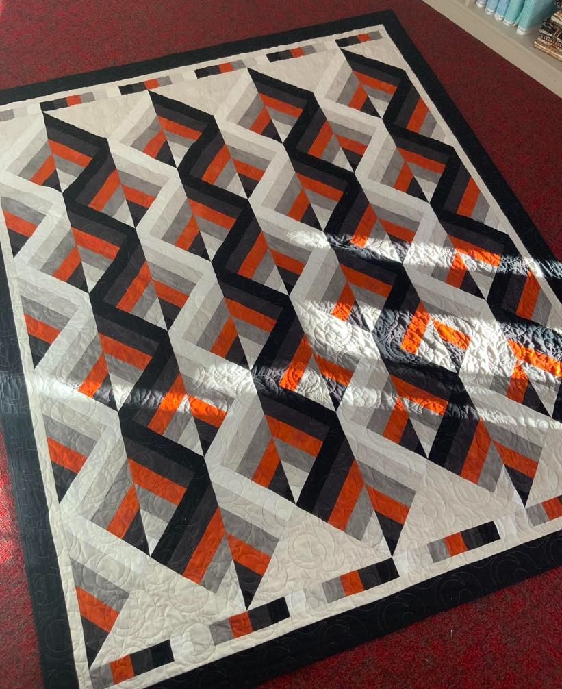 A Quilt With a Geometric Pattern is on a Red Carpet — Stitch 2340 In Taree, NSW