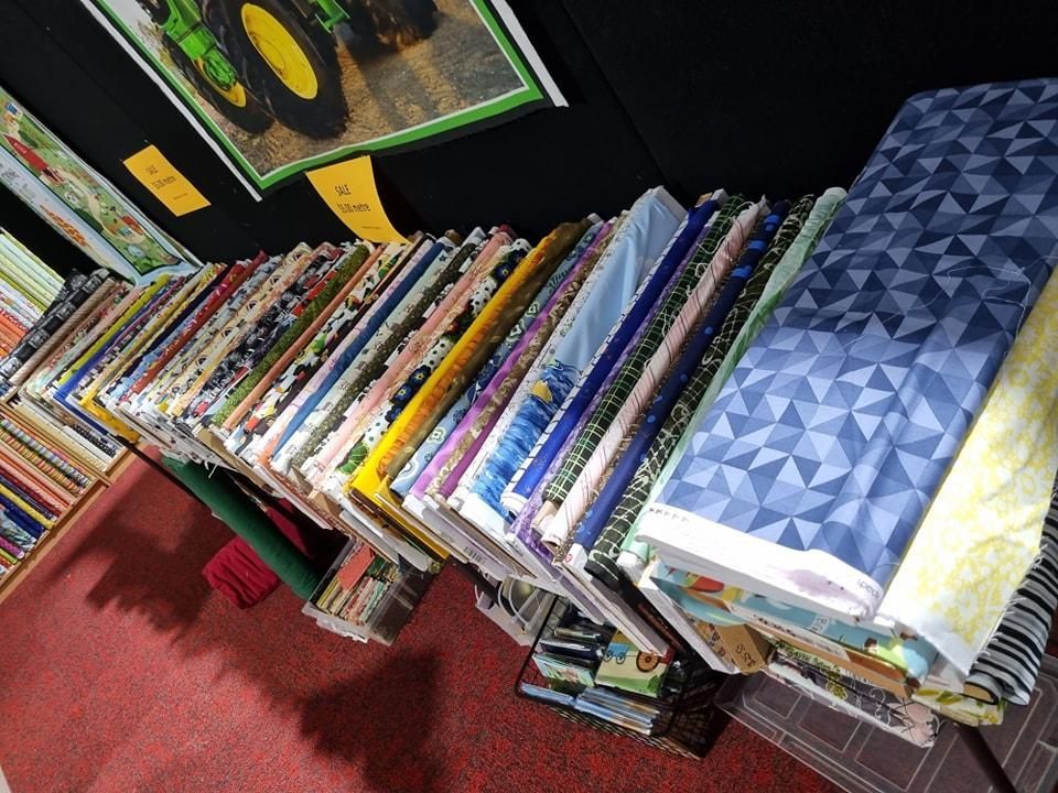 A Bunch of Fabrics Are Stacked on Top of Each Other on a Shelf — Stitch 2340 In Armidale, NSW