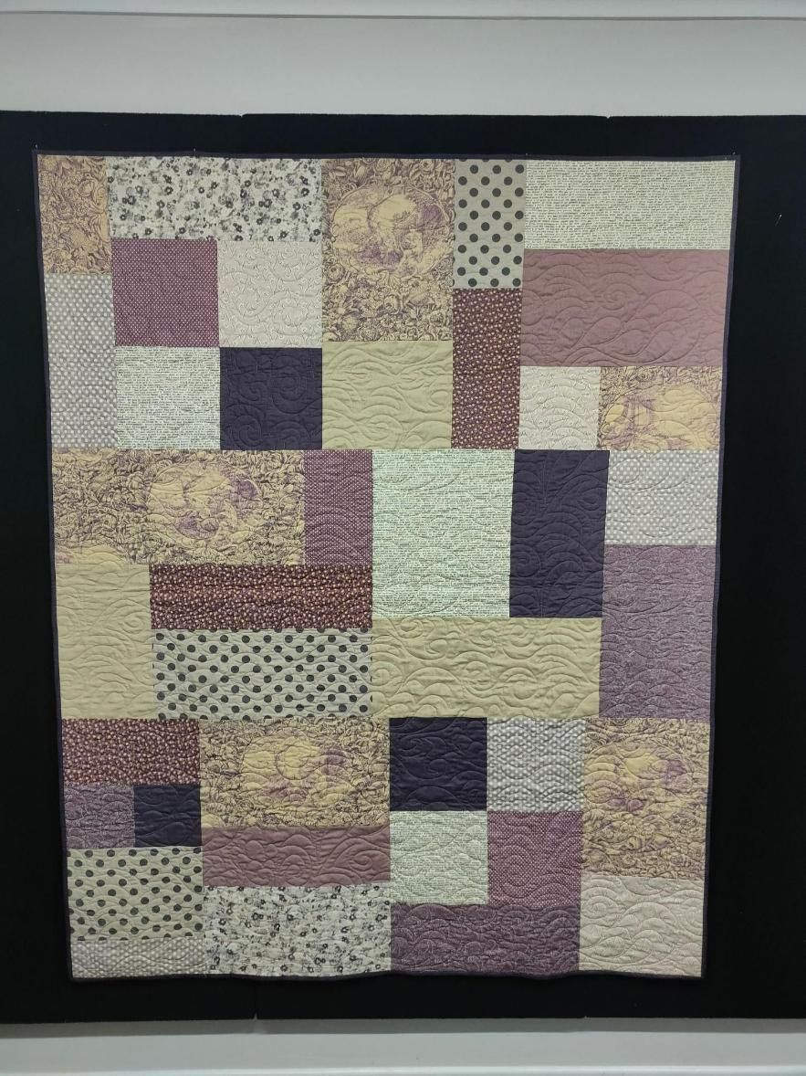 A Quilt Is Hanging on A Wall with A Black Frame — Stitch 2340 In Gunnedah, NSW