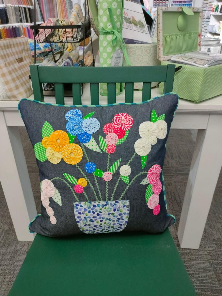 A Pillow with Flowers on It Is Sitting on A Chair — Stitch 2340 In Tamworth, NSW
