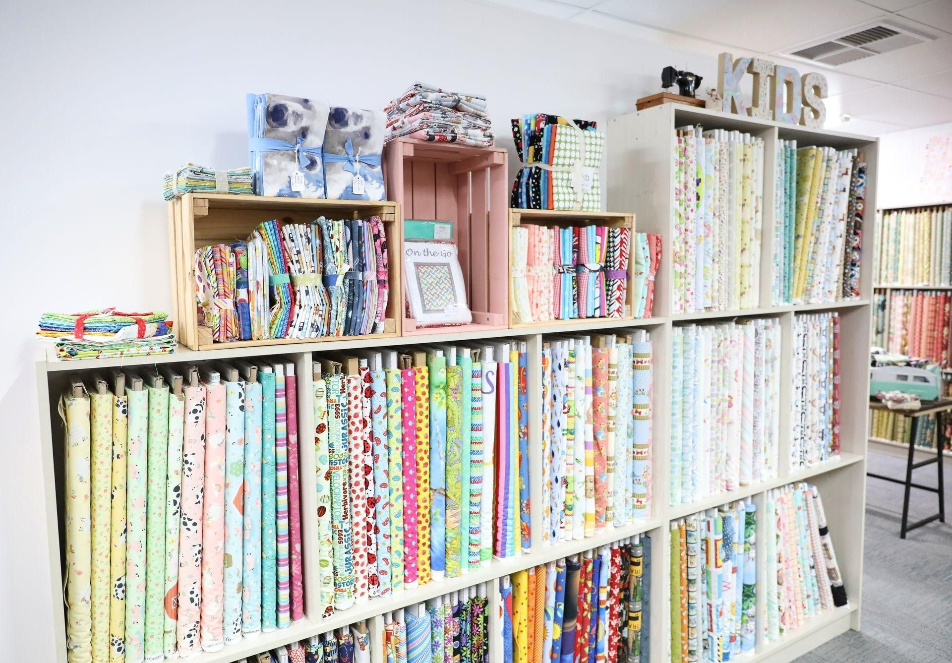 A Shelf Filled with Books and Fabrics in A Store — Stitch 2340 In Port Macquarie, NSW