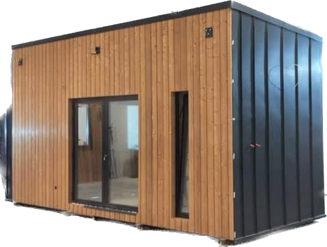 Modern cabin with wood siding and black metal roof and side.