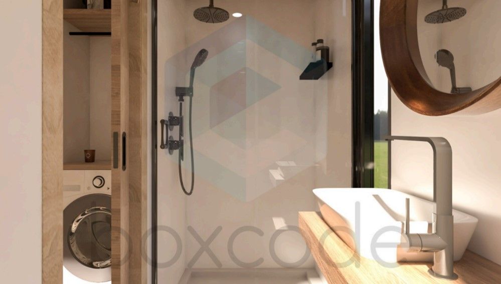 Bathroom with a glass-walled shower, vessel sink, and washing machine in wooden cabinetry.