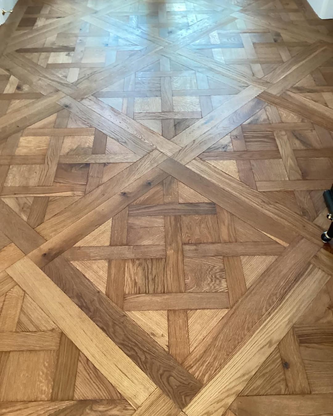 A Close Up of a Wooden Floor With a Pattern on It — Timberfection Queensland in Yatala, QLD