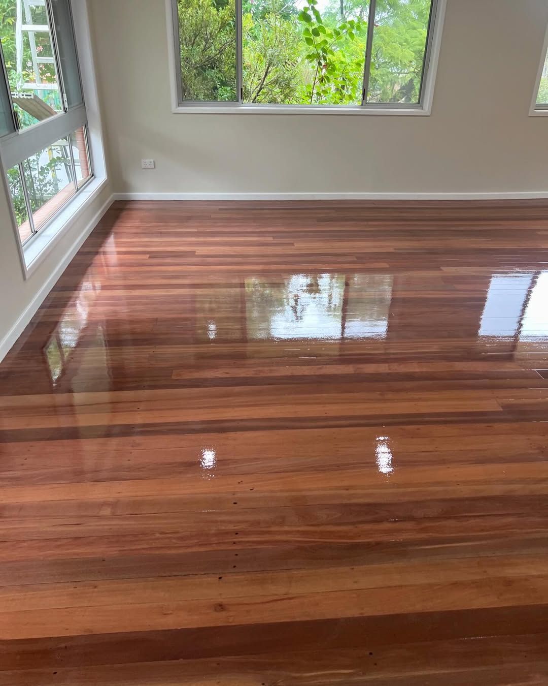 A Wide Room With a Brown Floor and a Window — Timberfection Queensland in Yatala, QLD