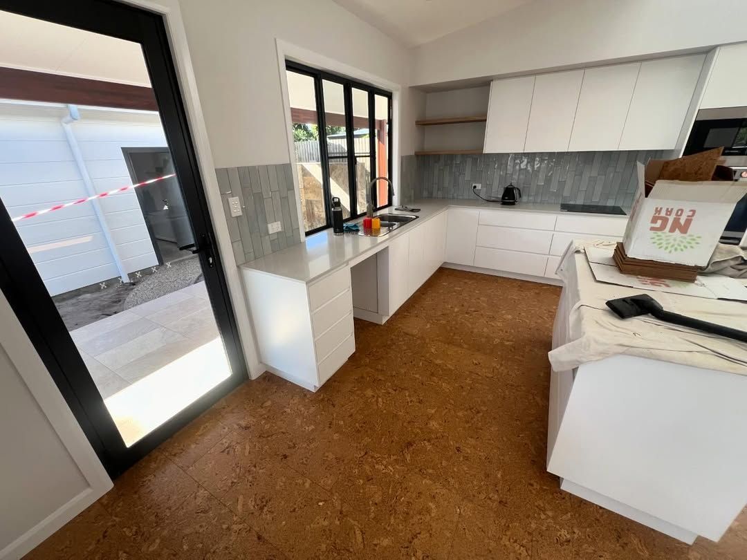 A Kitchen With White Cabinets and a Cork Floor — Timberfection Queensland in Yatala, QLD