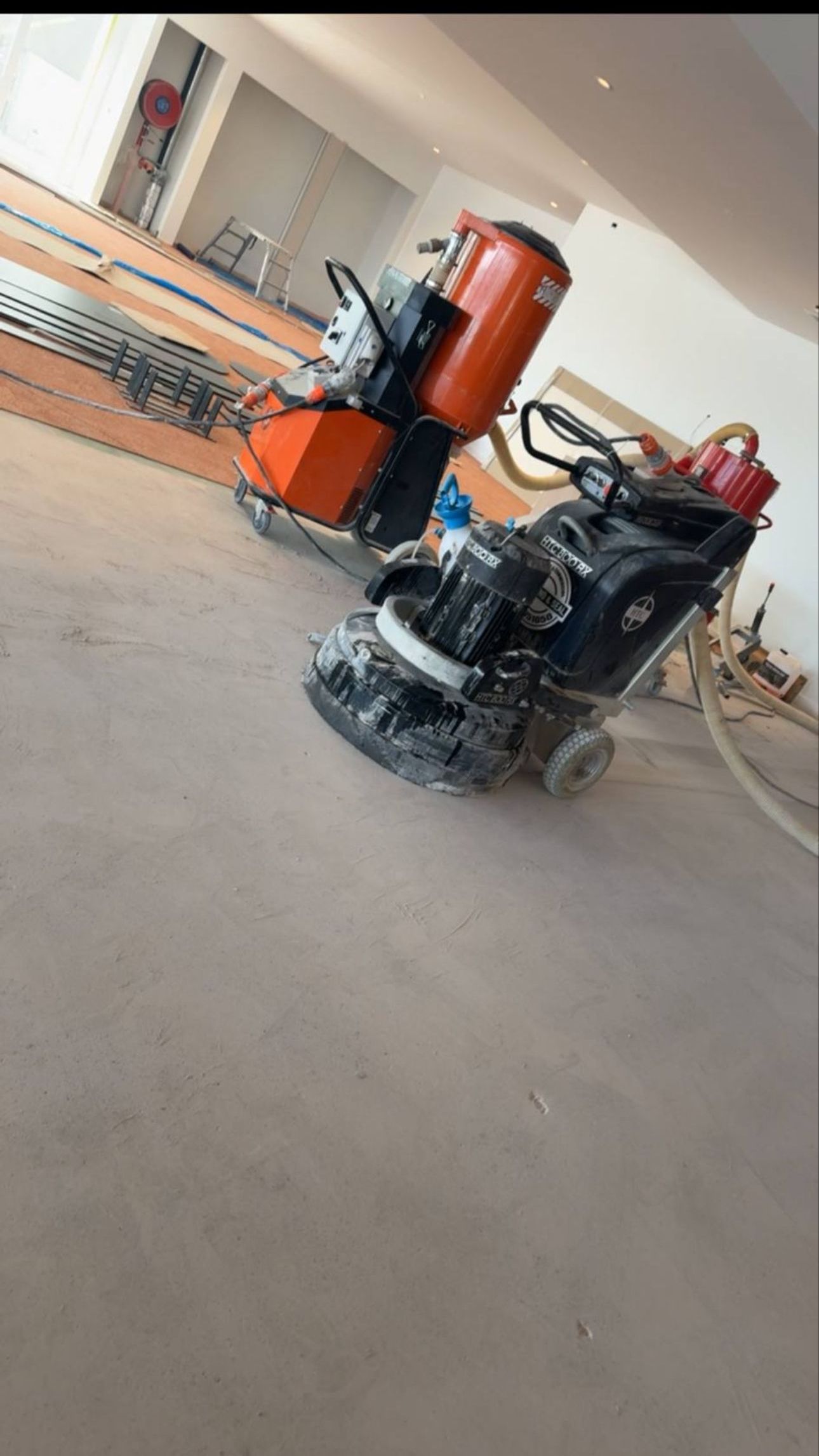 A man is using a machine to polish a black floor. — Timberfection Queensland in Yatala, QLD