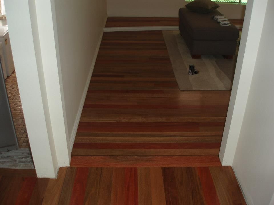 A Hallway With Wooden Floors Leading to a Living Room — Timberfection Queensland in Yatala, QLD