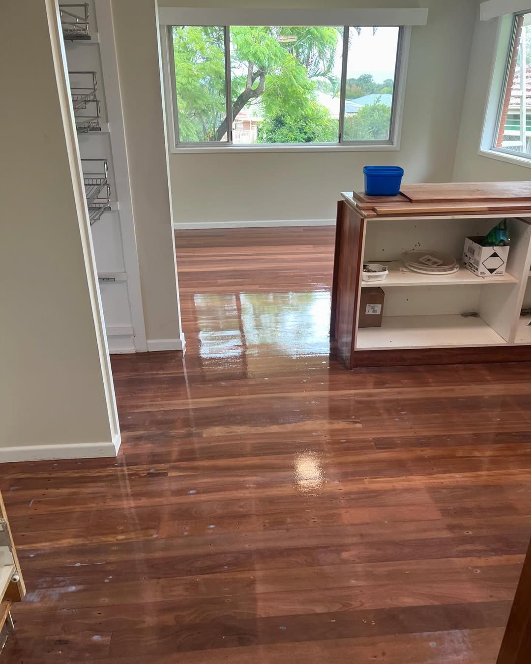 A Living Room With Hardwood Floors and a Window — Timberfection Queensland in Yatala, QLD