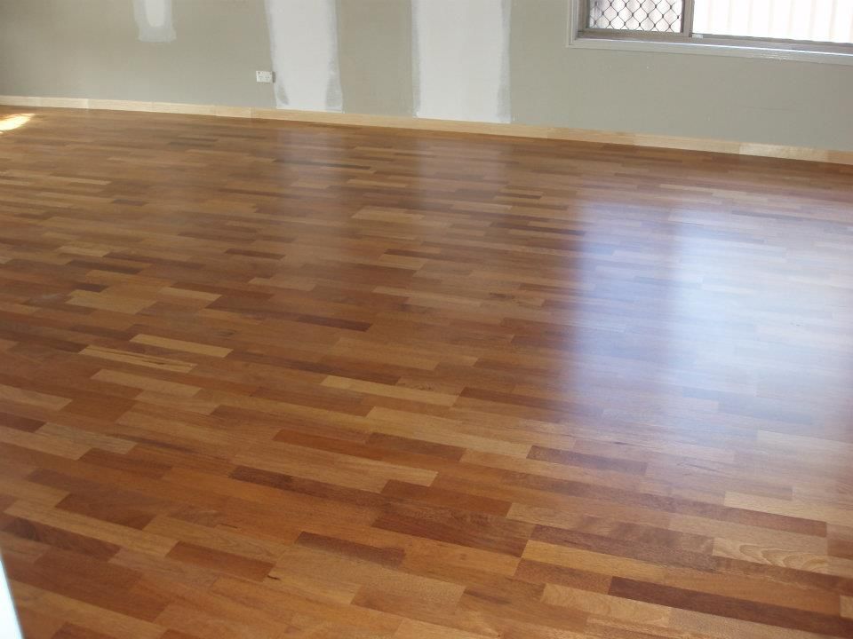 A Large Empty Room With a Wooden Floor and a Window — Timberfection Queensland in Yatala, QLD