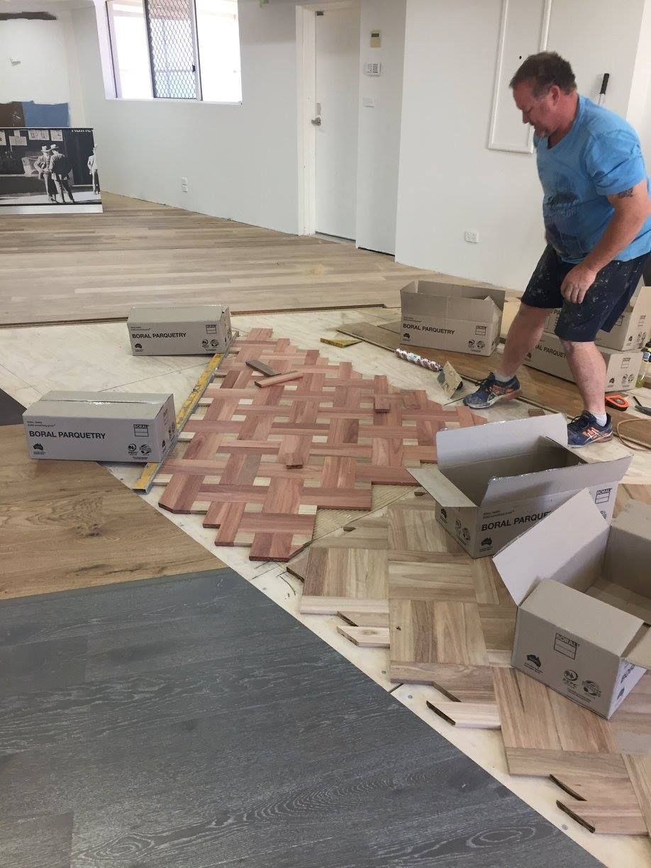 A Man is Standing on a Wooden Floor in a Room — Timberfection Queensland in Yatala, QLD