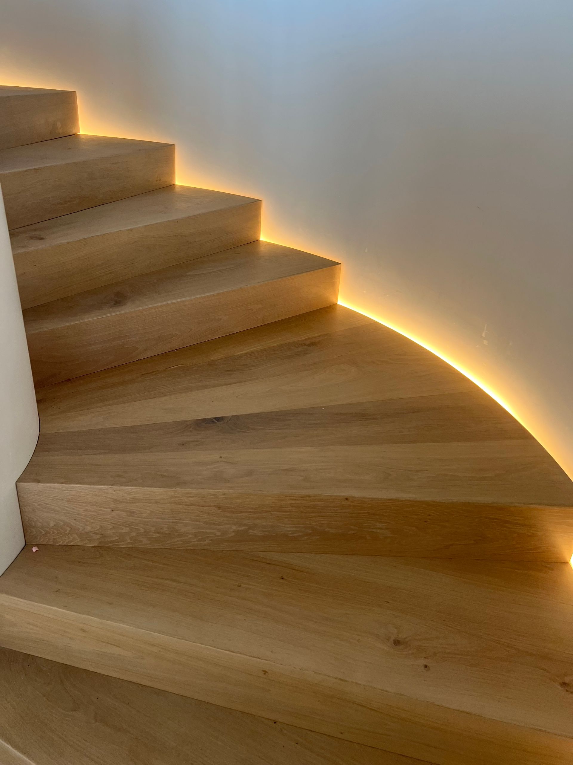 A Long Hallway in a Kitchen With Hardwood Floors and a Table — Timberfection Queensland in Yatala, QLD
