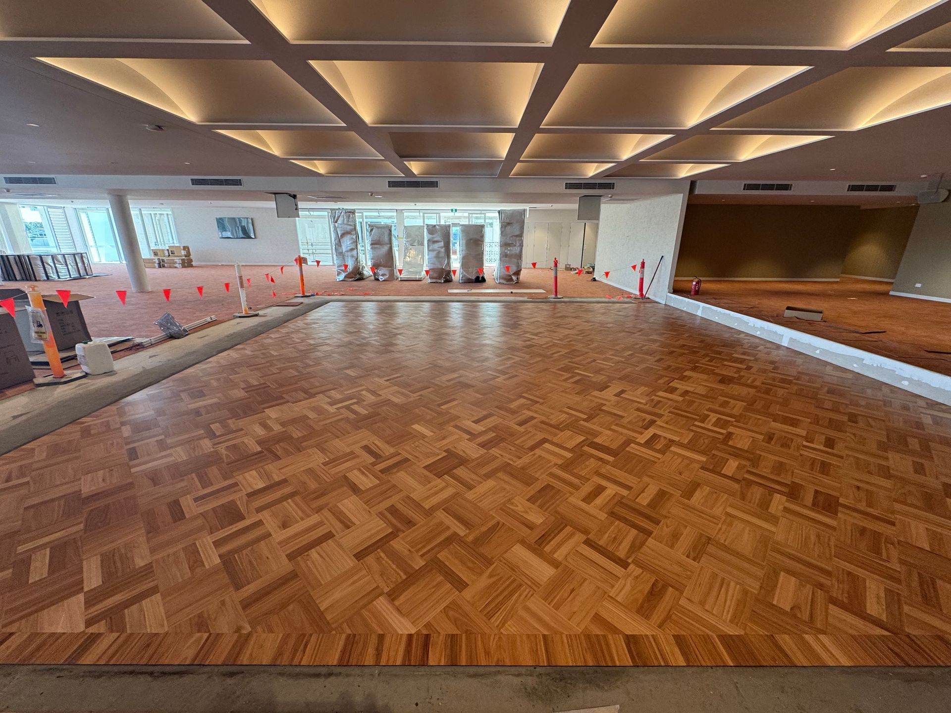 A Wooden Floor With a Herringbone Pattern in a Room — Timberfection Queensland in Yatala, QLD