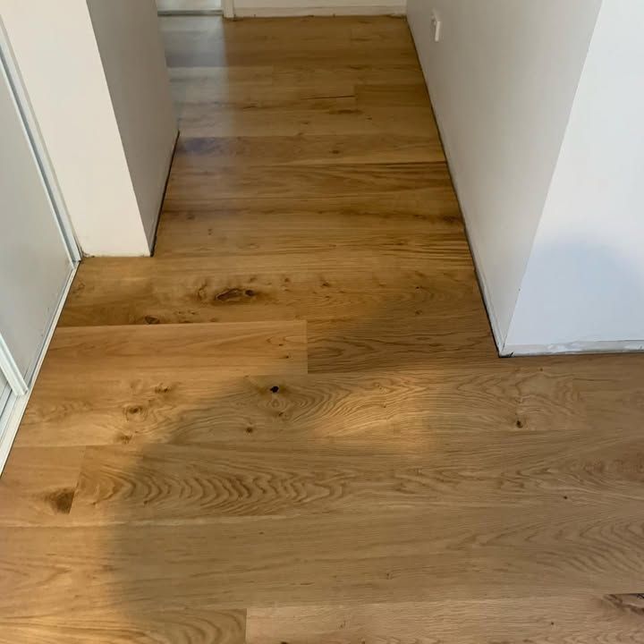 A Hallway With a Wooden Floor and a White Wall — Timberfection Queensland in Yatala, QLD