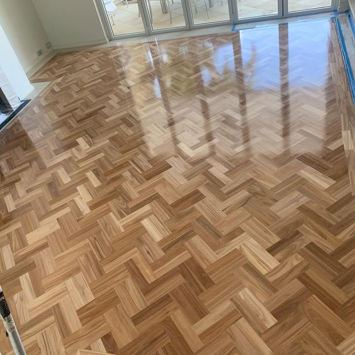 A Wooden Floor With a Herringbone Pattern in a Living Room — Timberfection Queensland in Yatala, QLD