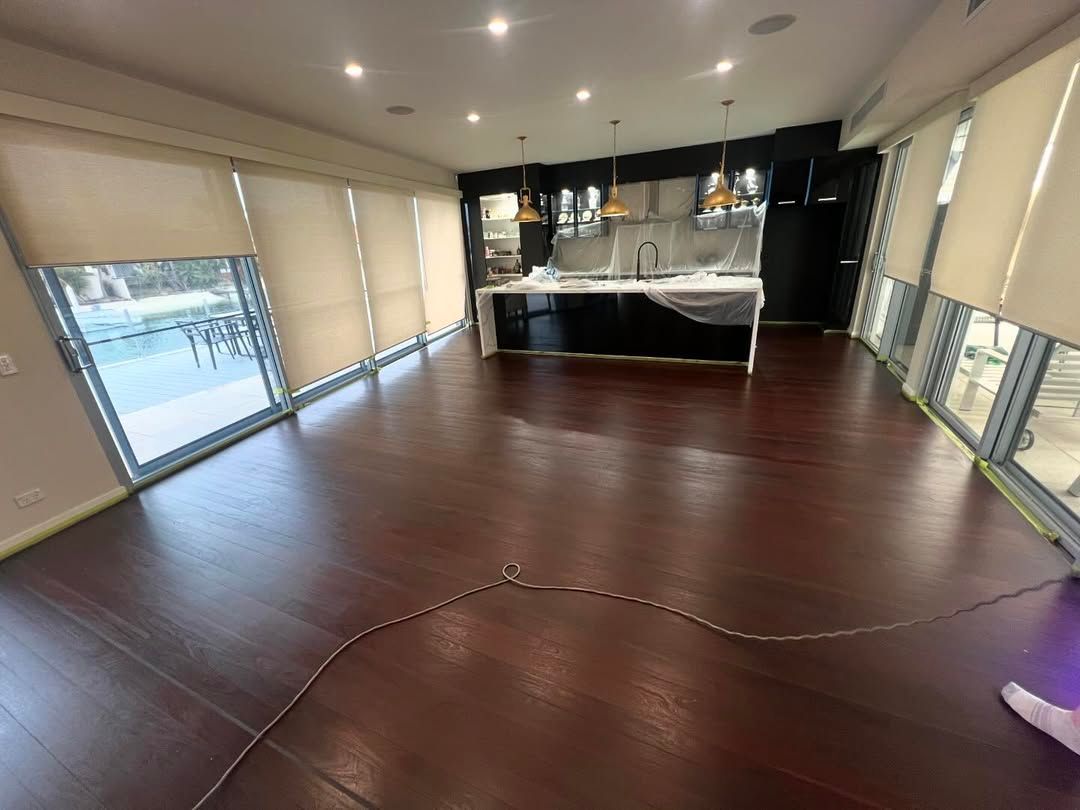 A Large Empty Room With Hardwood Floors and Lots of Windows — Timberfection Queensland in Yatala, QLD