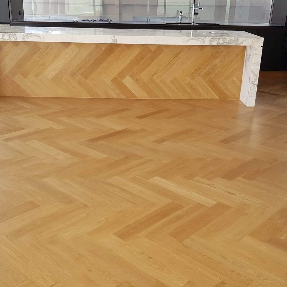 A Kitchen With a Wooden Floor and a Marble Counter Top — Timberfection Queensland in Yatala, QLD