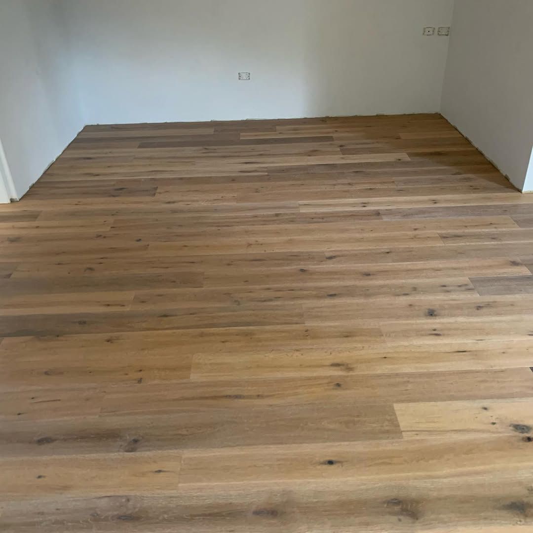 An Empty Room With a Wooden Floor and White Walls — Timberfection Queensland in Yatala, QLD