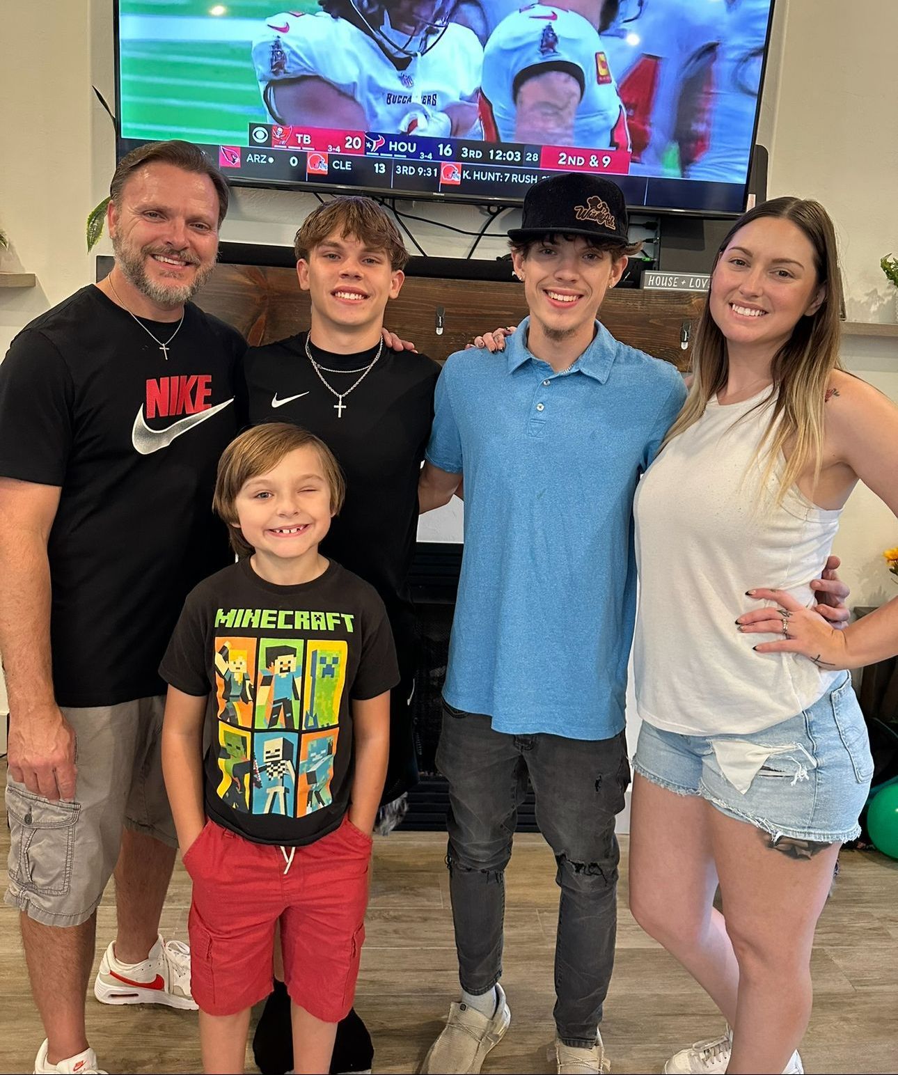 A man is holding a wrench and giving a thumbs up.