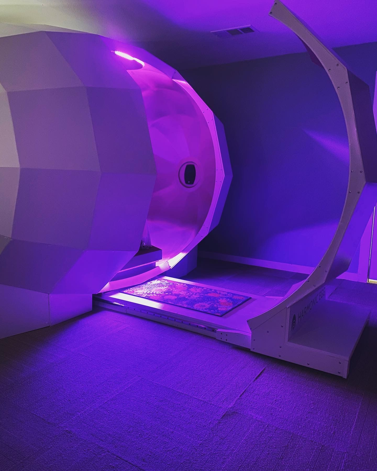 A room with purple lights on the walls and floor.