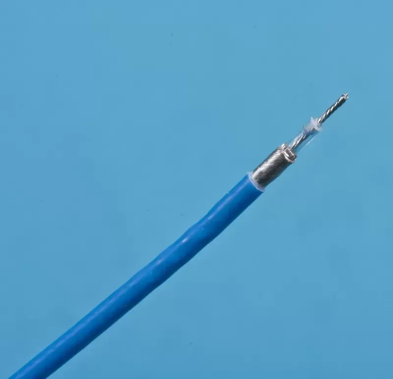 A blue electrical cable with its outer insulation stripped back to reveal a metal shielding and a central wire.