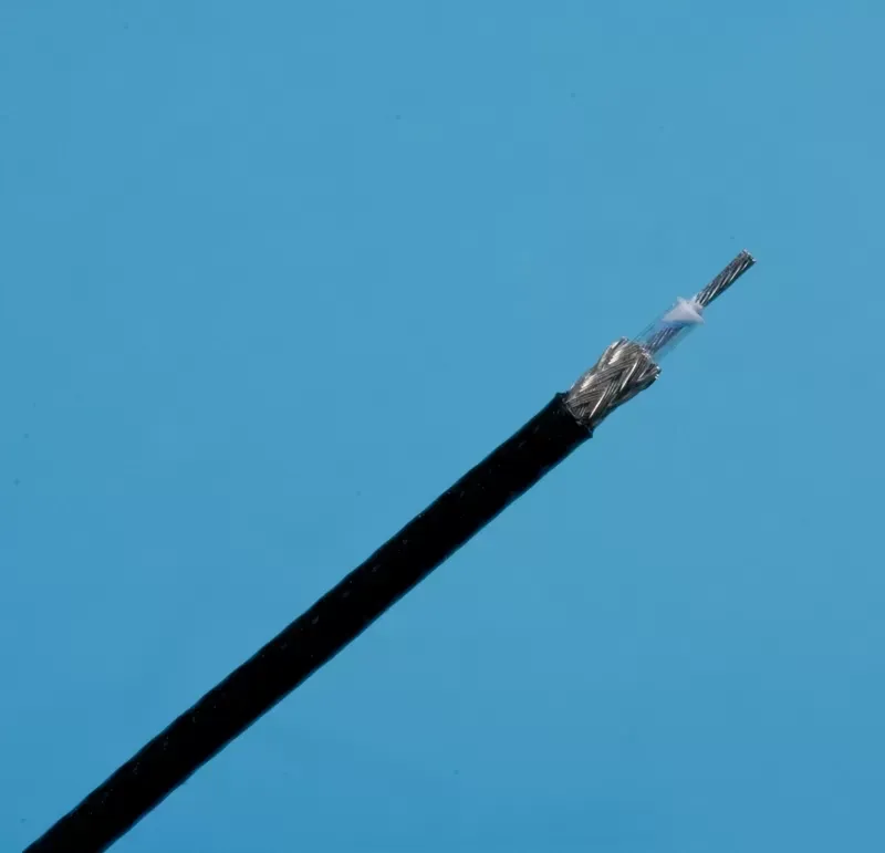 A black coaxial cable with the outer insulation stripped back to reveal the metallic braided shield and center conductor.