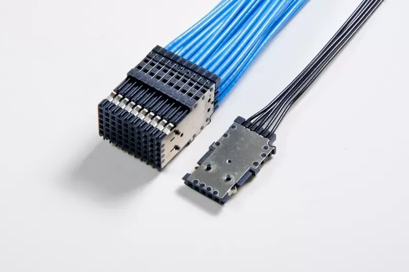 Two electrical connectors with blue and black wiring against a plain white background.
