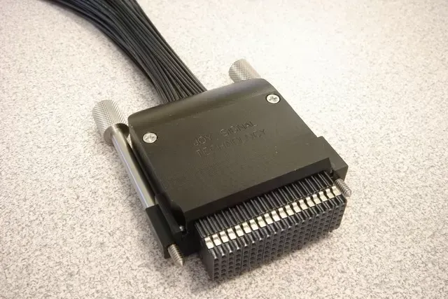 A black 96-pin DIN 41612 connector with a black housing and metal locking screws, viewed from a high angle.