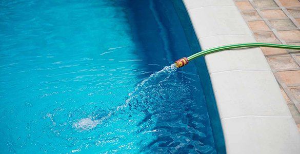 Flowing Water From The Hose To The Pool — Water Delivery Services In Maleny, QLD