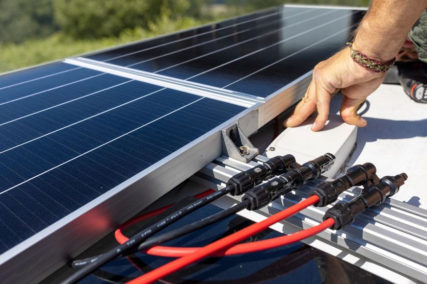 a person is installing solar panels on a roof