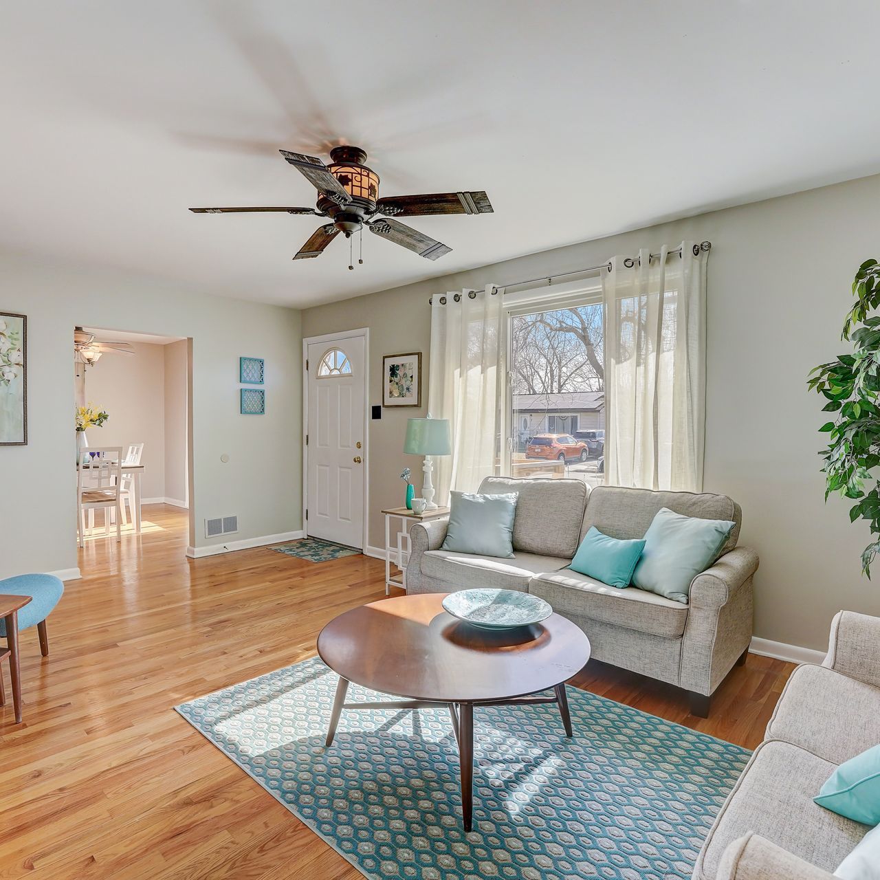 A living room with a ceiling fan and a couch