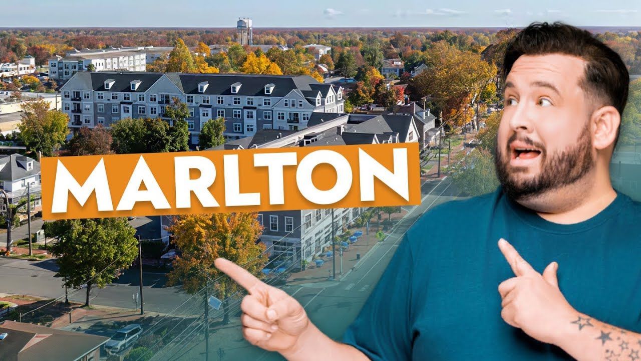 A man is pointing at a sign that says marlton