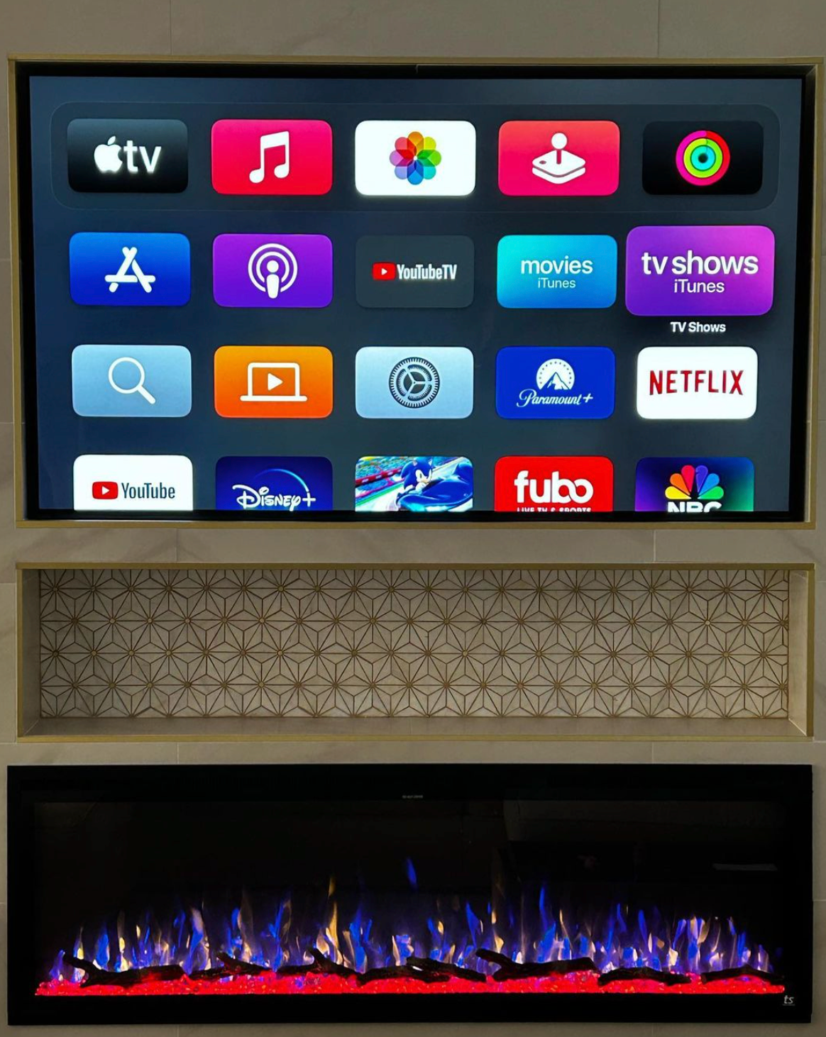 A flat screen tv is mounted to a wall next to a fireplace.