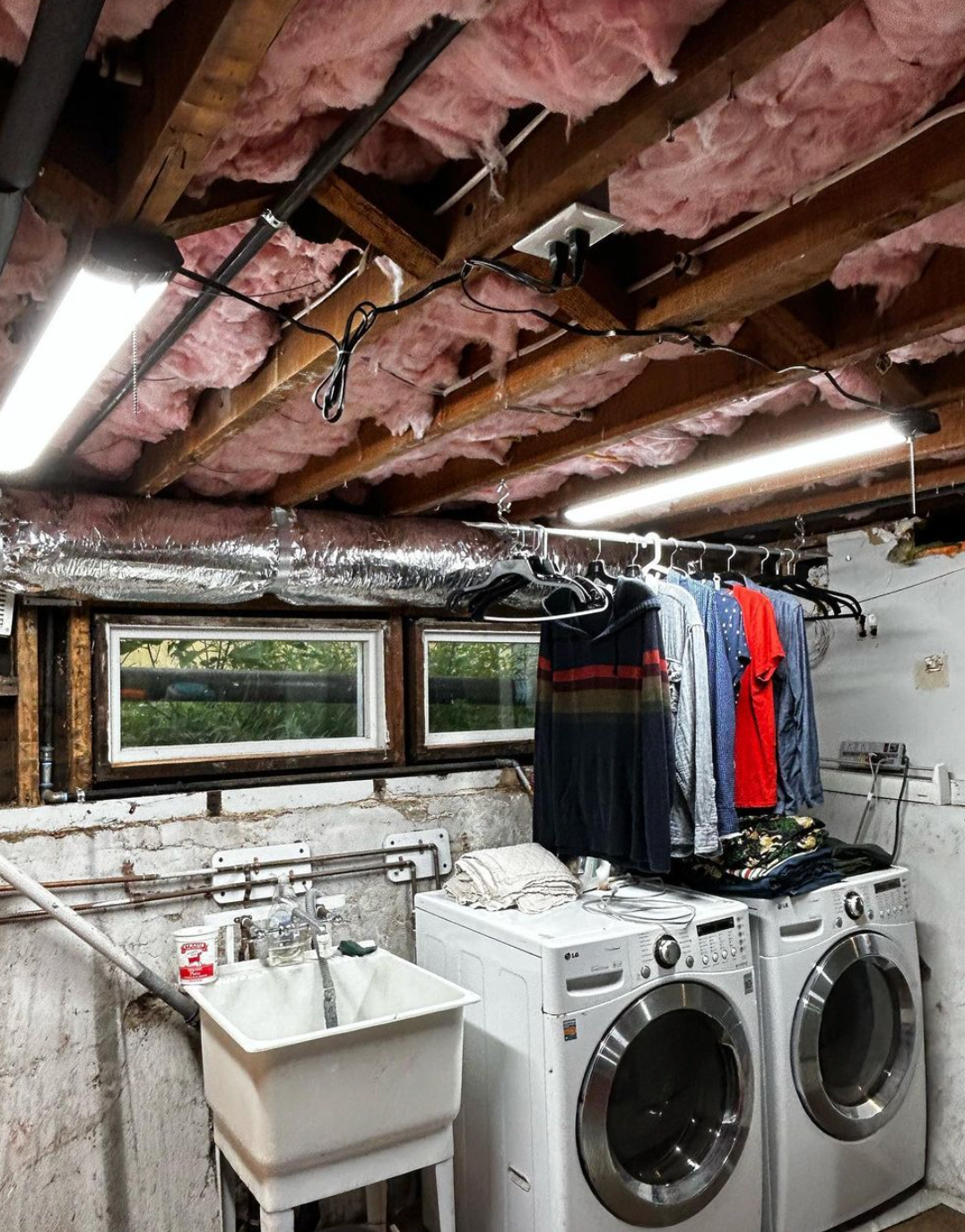 A laundry room with a washer and dryer and a sink.