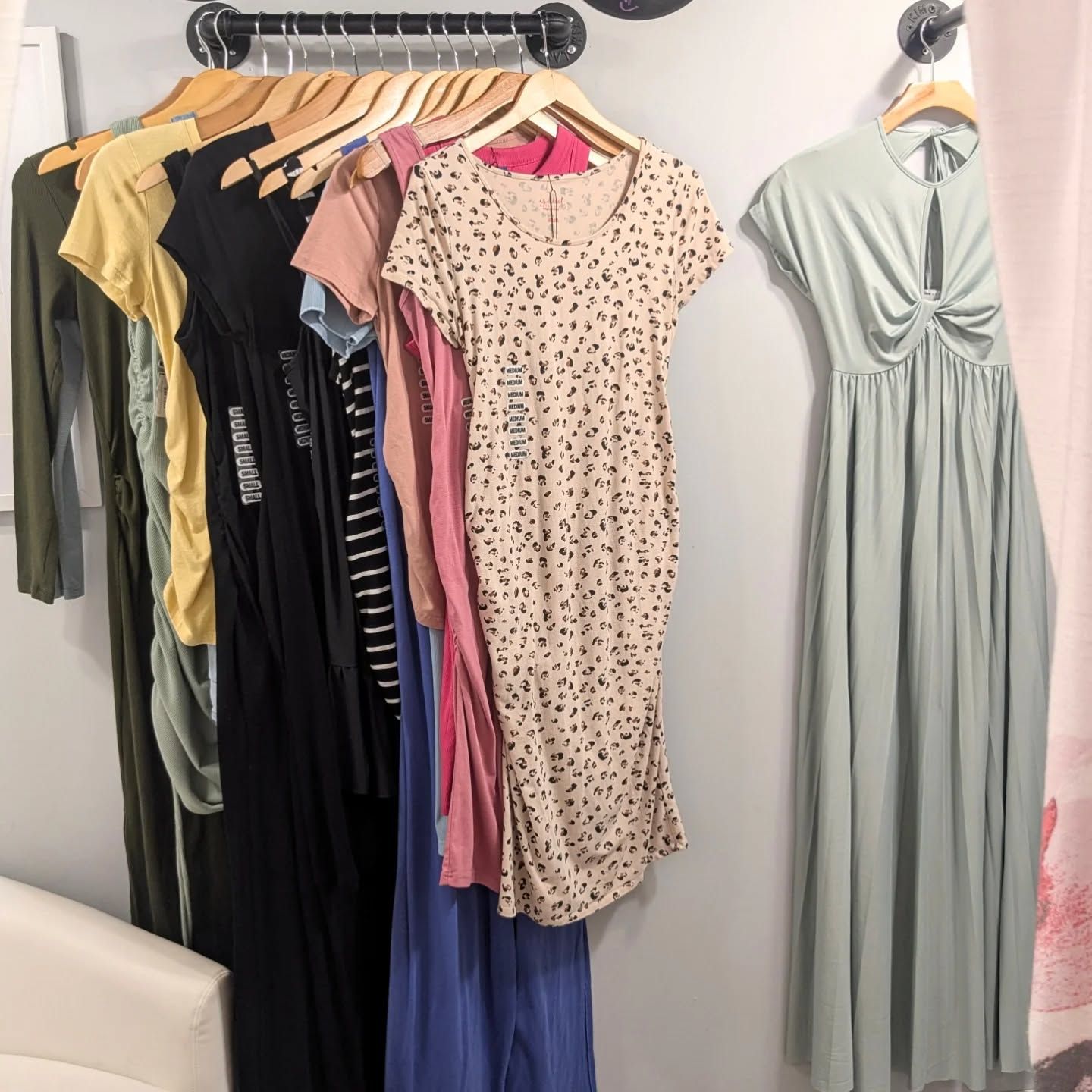 A bunch of dresses are hanging on a rack