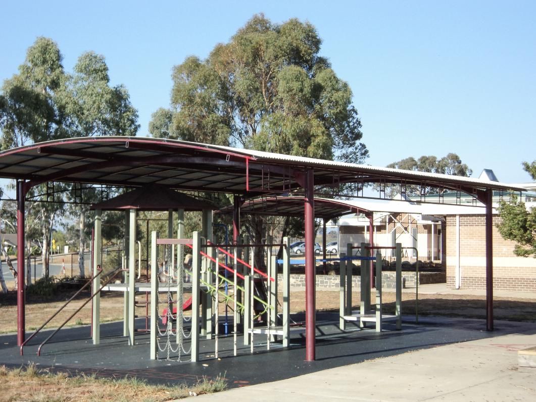 A Playground with A Red Roof and Trees in The Background — Clearspan Builders In Queanbeyan East, NSW